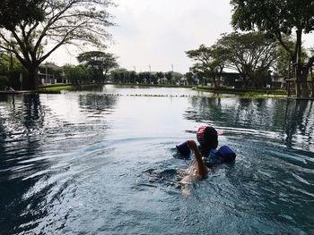 Man in water against sky