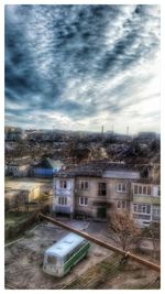 Buildings against cloudy sky