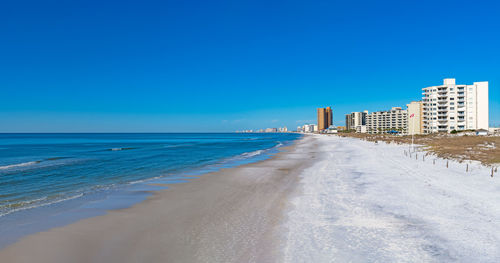 Scenic view of sea against clear blue sky