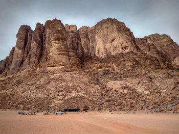 Low angle view of rock formation on land against sky