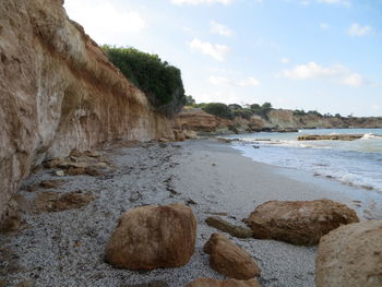 Rocks on beach against sky