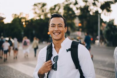 Portrait of smiling young woman standing outdoors