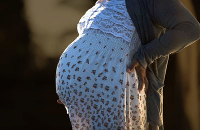 Midsection of woman wearing sweater