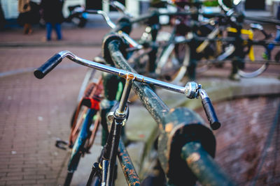 Close-up of bicycle by railing