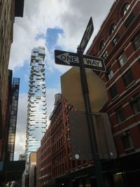 Low angle view of skyscrapers in city against sky