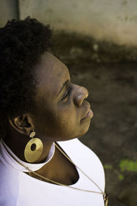 High angle view of thoughtful woman with tattoo looking away