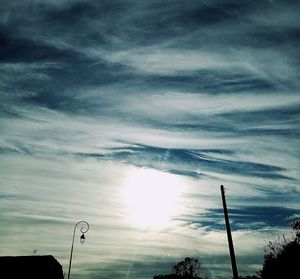 Silhouette landscape against cloudy sky