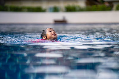 Little girl getting drowning in swimming pool