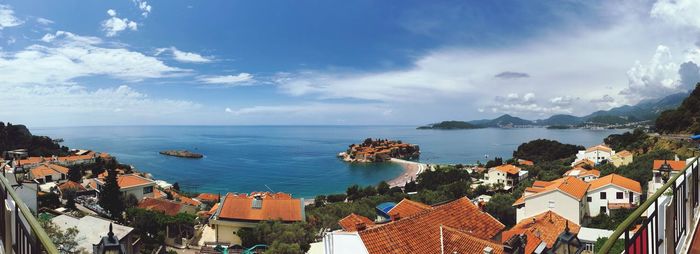 High angle view of townscape by sea against sky