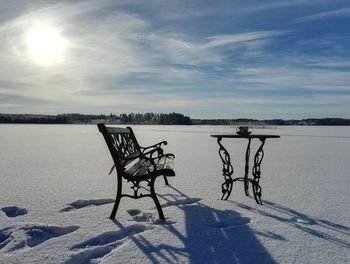 Bicycles on snow against sky during winter