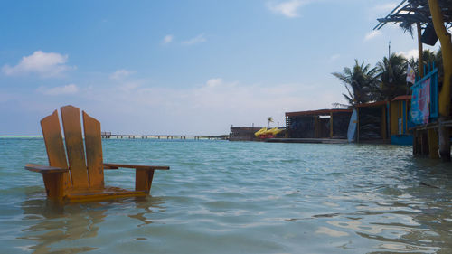 Chairs on beach against sky