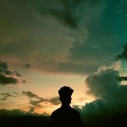 Silhouette man standing against sky during sunset