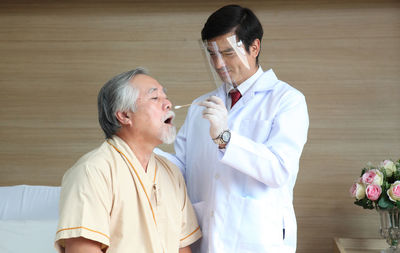 Doctor examining patient at home