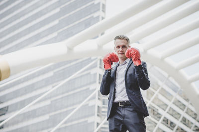 Portrait of businessman wearing boxing gloves