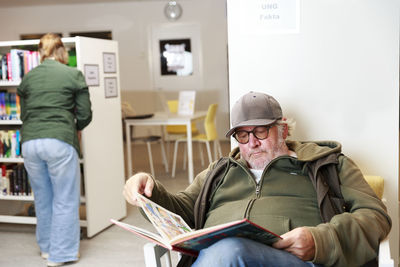 Senior man reading in library