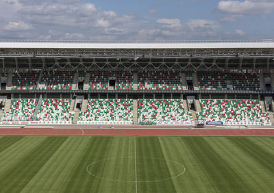 View of soccer field against cloudy sky