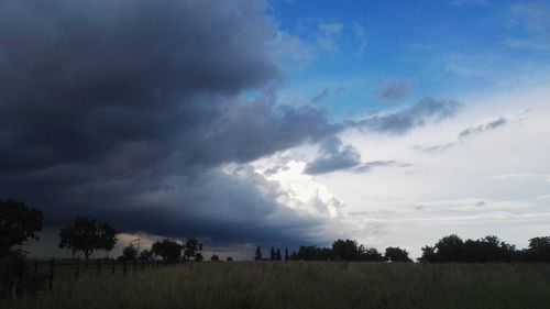 Panoramic shot of countryside landscape against cloudy sky