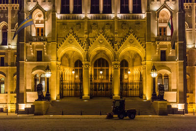 Snowplow in front of illuminated hungarian parliament building