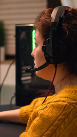 Portrait of woman using mobile phone at home