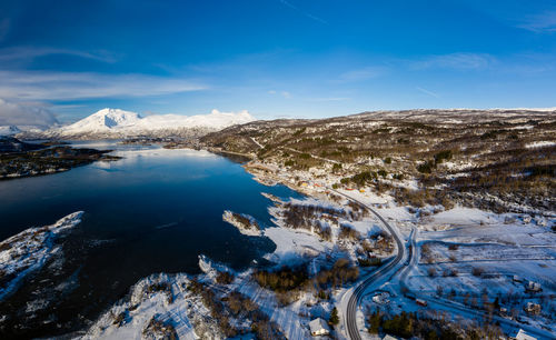 Scenic view of snowcapped mountains against blue sky