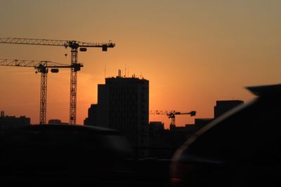 Silhouette buildings against sky during sunset