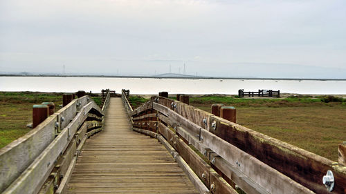 Pier over sea against sky