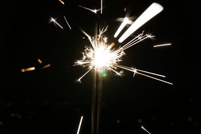 Low angle view of firework display at night