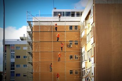 Workers working at construction site in city