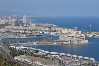 High angle view of cityscape by sea against sky