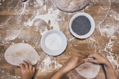 Hands kneading dough. people making dough for bread during bread making workshop. flour and dough