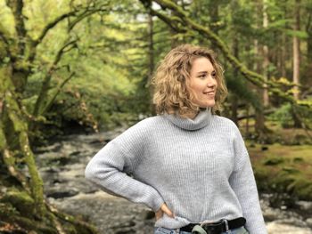 Portrait of teenage girl standing in forest