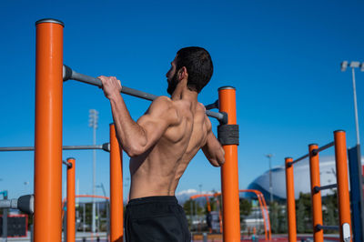 Rear view of muscular man exercising