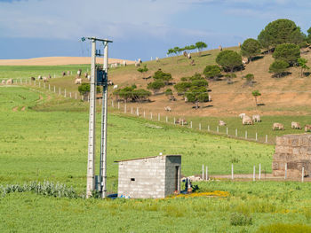 Built structure on field against sky