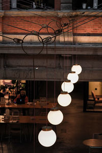 Illuminated electric lamp on table at restaurant