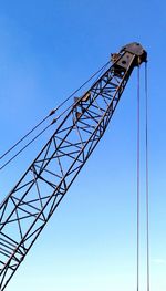 Low angle view of electricity pylon against clear sky