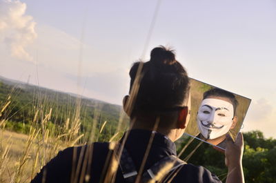 Portrait of friends standing against sky