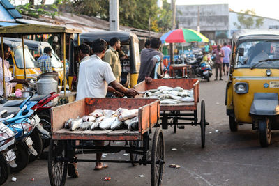 Rear view of people at market stall