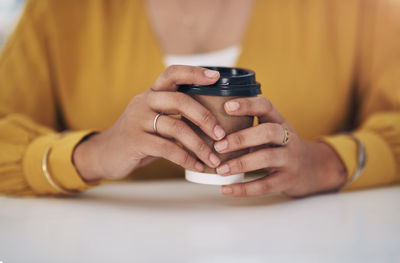 Midsection of woman using mobile phone