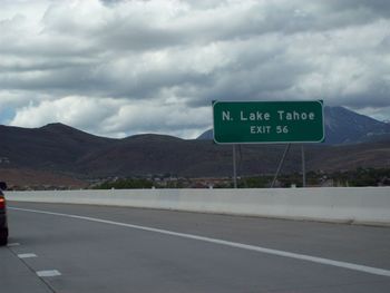 Close-up of road sign against sky