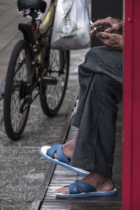 Low section of man riding bicycle on street