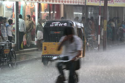 Blurred motion of people on motorcycle in city