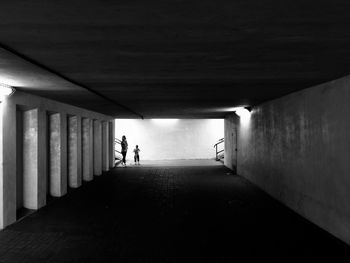 Silhouette people walking in corridor