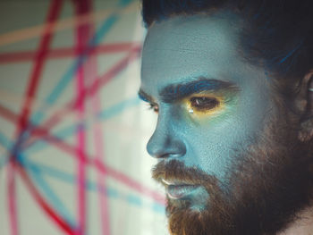 Close-up of serious man with painted face