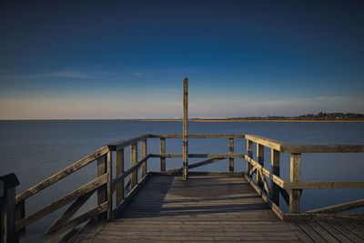 Pier over sea against sky