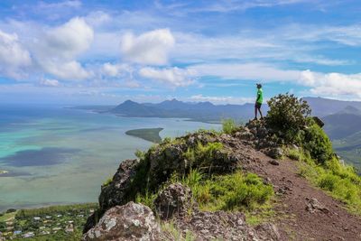 Man standing on mountain against sky