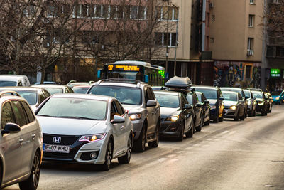 Cars on street against buildings in city