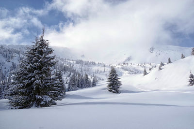 Scenic view of snow covered mountains against sky