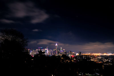 Illuminated buildings against sky at night