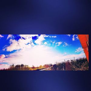 Panoramic view of landscape against blue sky