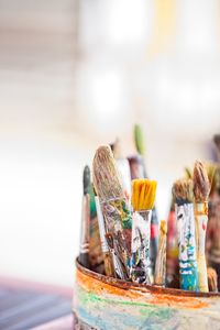 Close-up of paintbrushes in container on table